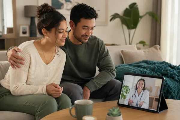 Couple at home on a video call with a GP for a private fertility and reproductive health consultation - Cha2GP